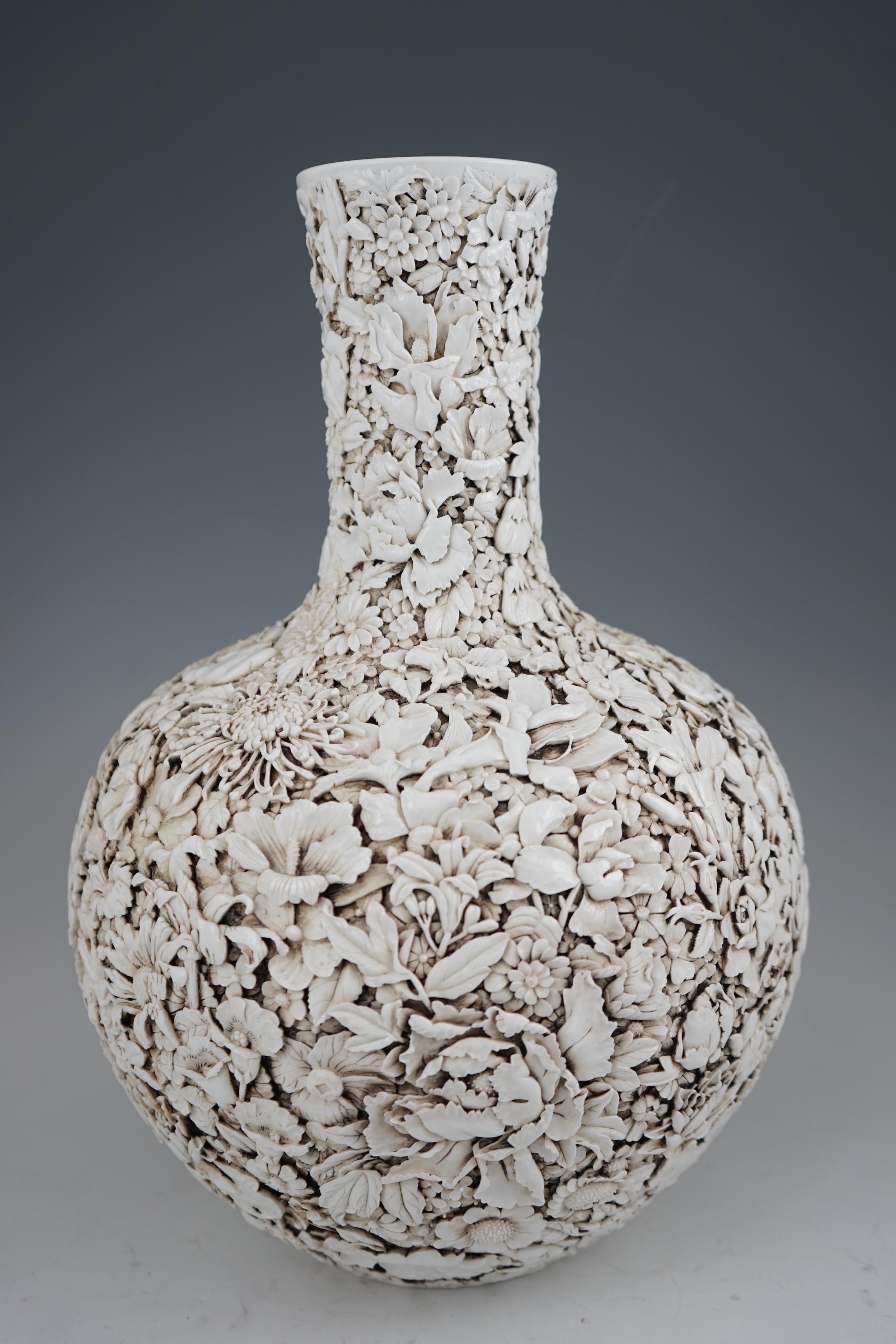 A large Chinese carved porcelain ‘thousand flower’ bottle vase, 20th century